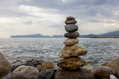 Stacked stones in the sea and the waves crashing onto them