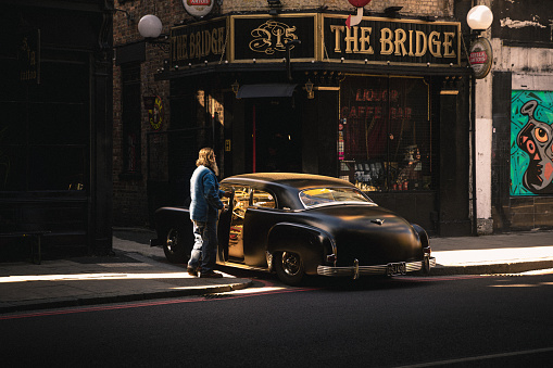 September 17, 2022: A matte black vintage car on a street in central London