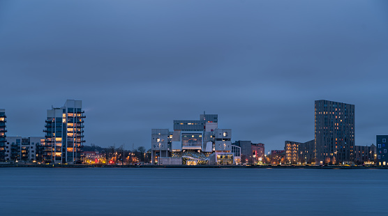 Evening cityscape panorama of the illuminated Aalborg, North Jutland Region (Nordjylland), Denmark. The House of Music (Musikkens Hus) in the center,