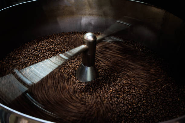 istock coffee beans and roasted spinning cover professional machine, close up to soft focus, take low speed photo to need movement and coffee beans detail concept, 1794649457
