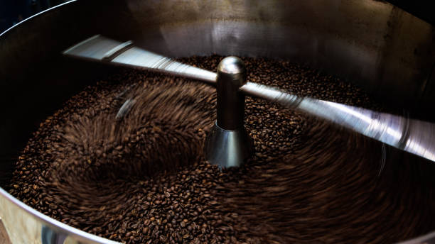 istock coffee beans and roasted spinning cover professional machine, close up to soft focus, take low speed photo to need movement and coffee beans detail concept, 1794649458