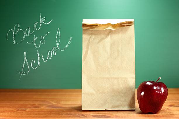 istock Lunch Sack Sitting on Teacher Desk With Apple 179466018