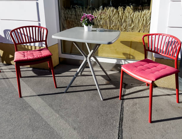 istock two red chairs and a gray table outside in the morning sun 1794664372