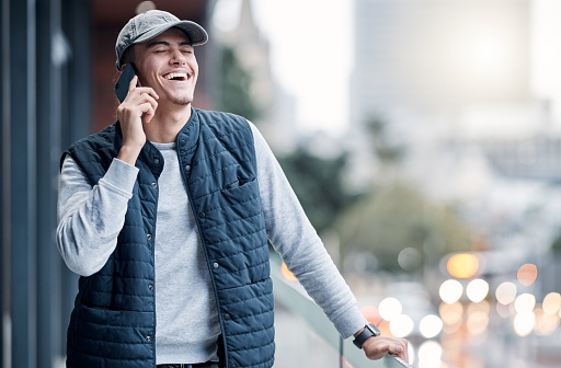 Phone call, communication and man happy in city for conversation, laughing and talking in New York. Networking, 5g connection and young male with smartphone for speaking, chatting and online contact