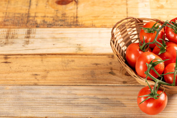 istock Tomatoes, beautiful arrangement with tomatoes in a basket on rustic wood, selective focus. 1794668181