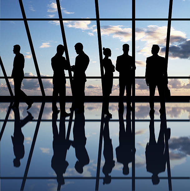 istock Silhouettes of businesspeople discussing issues by window 179466844