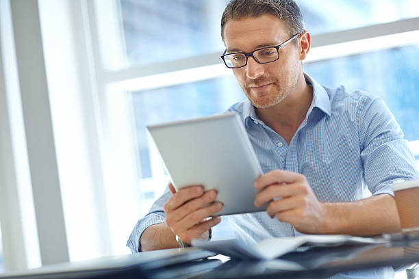 istock Engrossed in reading some online business reports 179466984