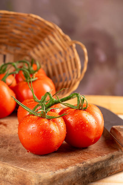 istock Tomatoes, beautiful arrangement with tomatoes in a basket on rustic wood, selective focus. 1794670619