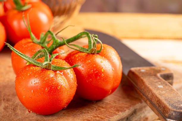 istock Tomatoes, beautiful arrangement with tomatoes in a basket on rustic wood, selective focus. 1794670622