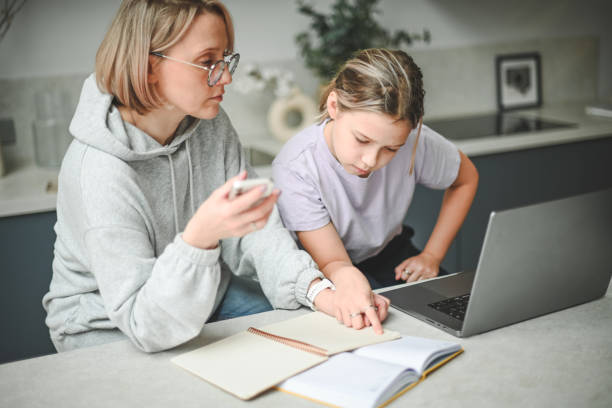 istock mother and daughter doing homework 1794676126