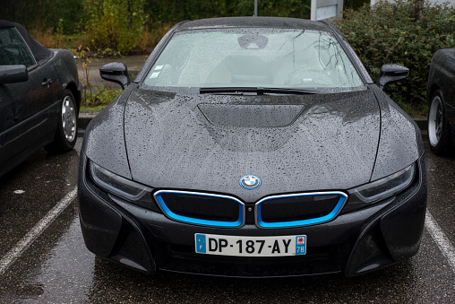 Mulhouse - France - 12 November 2023 - Front view of black e bmw parked in the street by rainy day
