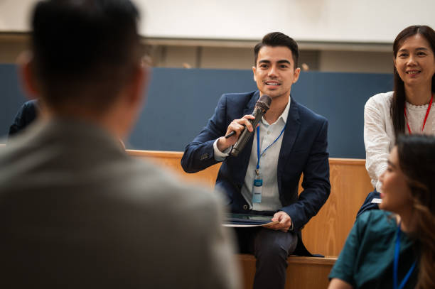 istock Finding Common Ground: A Multiracial Business Seminar's Question Time in a Modern Office - Business conference APAC 1794691385