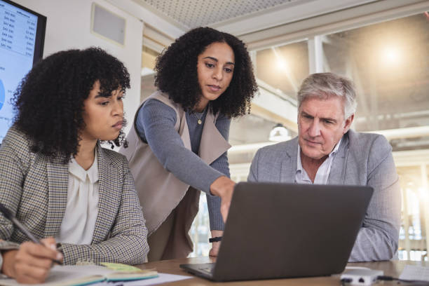 istock Training, business people on laptop for creative, collaboration or coaching on project review in office. Corporate, women and mentor with report, kpi and planning or teamwork idea for online proposal 1794691917