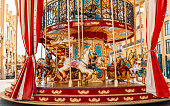Children’s vintage carousel in the form of horses in a holiday park.