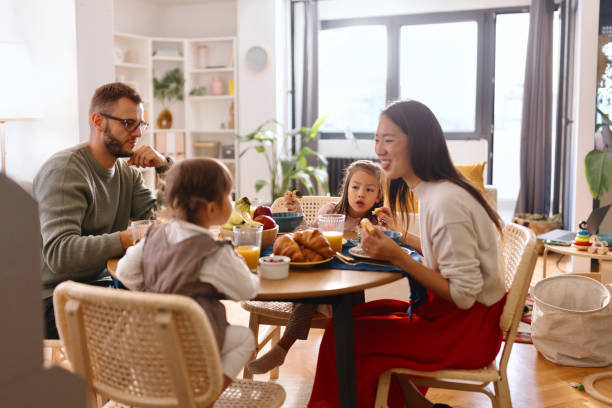 istock Smiling family sitting at the dining table and having breakfast 1794709908