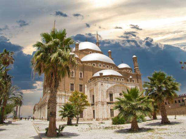 istock a very large building next to some tall palm trees and people walking by it 1794722502