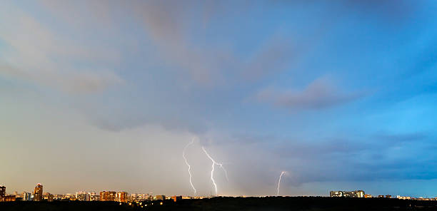 istock thunderbolts in dark blue sky over city 179473840