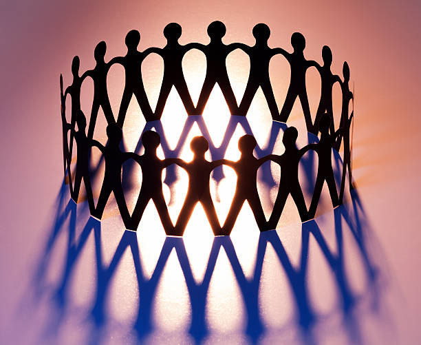 Ring of Unity Ring of Unity. Cut-out paper people joining in network, family, team, Brotherhood. line of people holding hands stock pictures, royalty-free photos & images