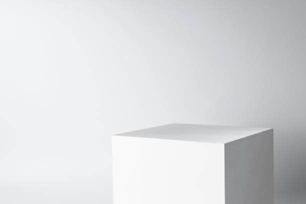 istock blank mockup template empty square box platform pedestal cube to display isolated white clean background with grey shadow wall 1794754980