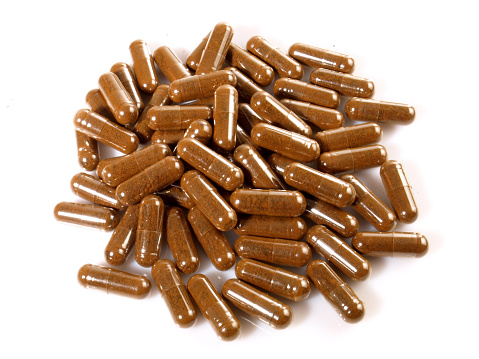 Chaga Mushroom Capsules isolated on white Background - Healthy Nutrition