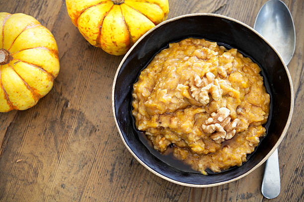 Pumpkin oatmeal Autumn morning pumpkin oatmeal with walnuts oats food stock pictures, royalty-free photos & images