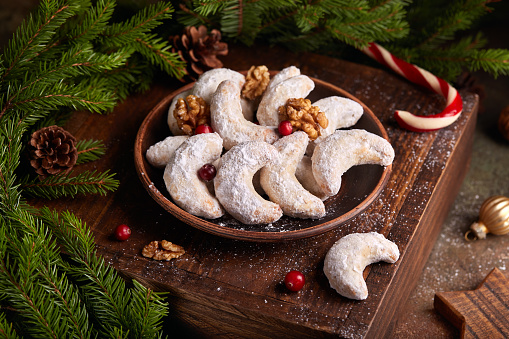 Crescent Christmas Cookies with walnuts covered with sugar powder. Delicious homemade dessert in a shape of half moon.