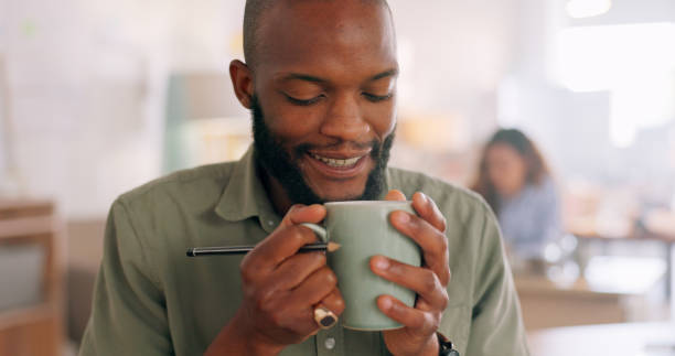 istock Aroma, cup and man smell coffee for inspiration while working, design and planning in startup. Creative black man, cafe and fragrance of drink to start morning at graphic design business in Atlanta 1794788453
