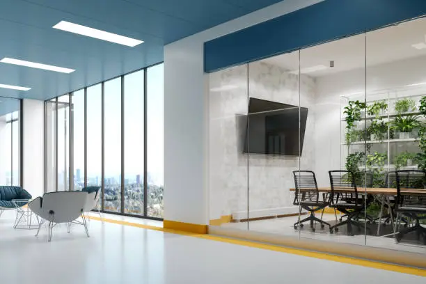 Modern office space with minimalist design highlighted by a clean color scheme of white, accented with blue and yellow details.