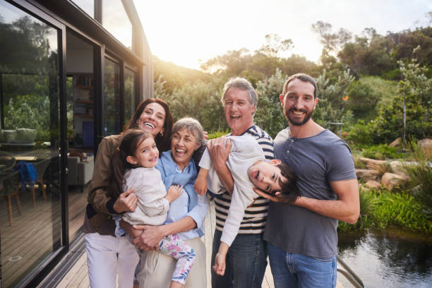 istock Laughing multi-generation family standing together outside in summer 1794799236