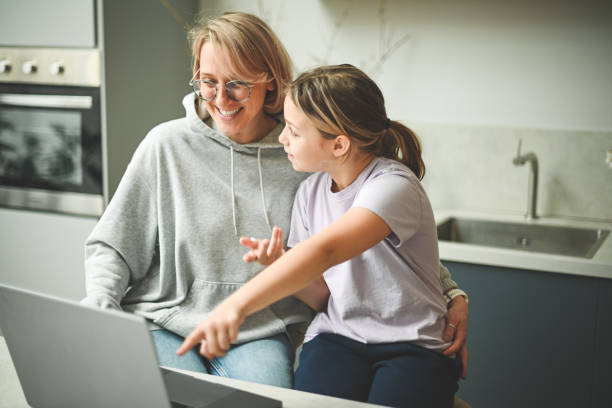 istock mother and daughter (with laptop) 1794806177