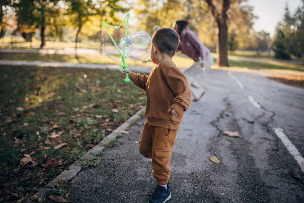 Mother and son making bubbles in the park