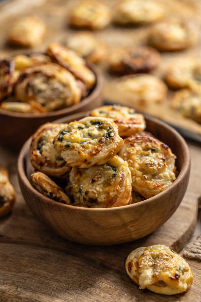 istock Mini pizza rolls stuffed with various ingredients, prosciutto bacon spinach basil mozzarella or parmesan cheese in wooden bowl. 1794833465