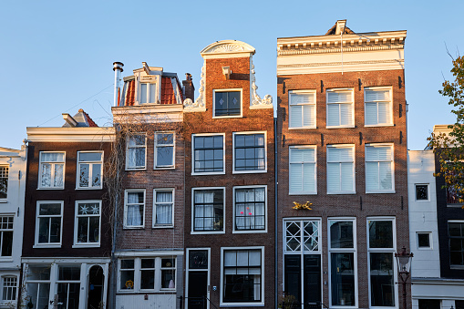 Front view of historic canal houses in Amsterdam, The Netherlands.