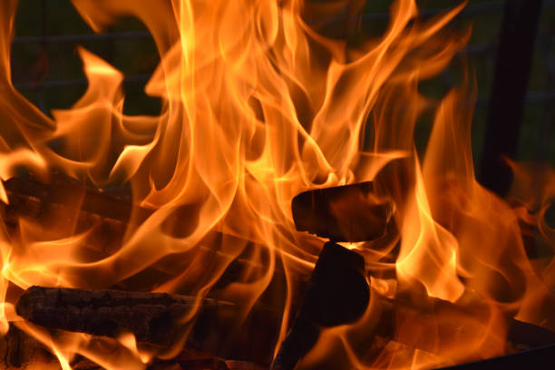 istock Fire flames and sparks close up on black background. Space for typography 1794847201