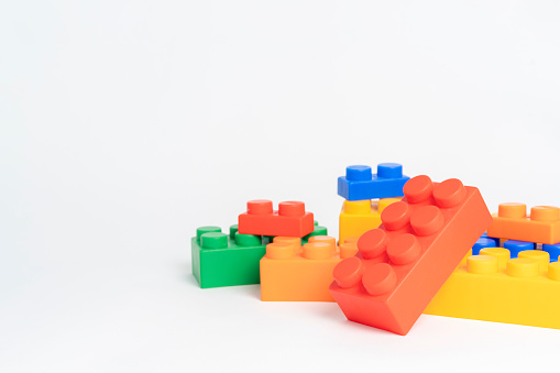 pile plastic toy blocks on white background