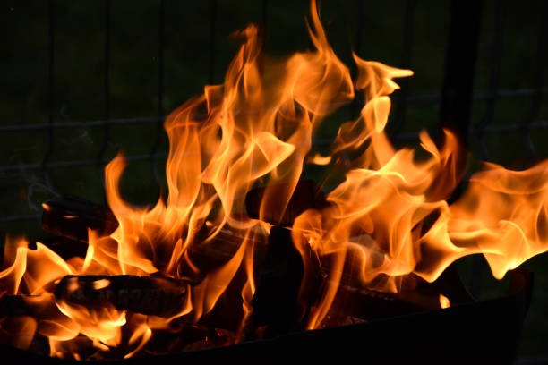 istock Fire flames and sparks close up on black background. Space for typography 1794848250