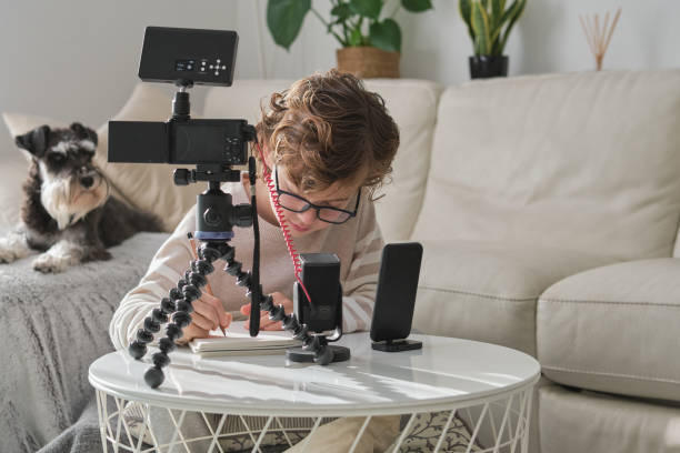 istock Creative boy recording video for blog at home 1794872360