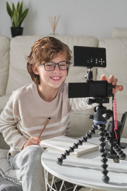 istock Positive boy making video for blog using professional equipment 1794873519