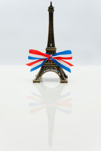 A miniature Eiffel Tower with a ribbon.