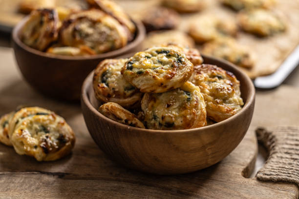 istock Mini pizza rolls stuffed with various ingredients, prosciutto bacon spinach basil mozzarella or parmesan cheese in wooden bowl. 1794880427