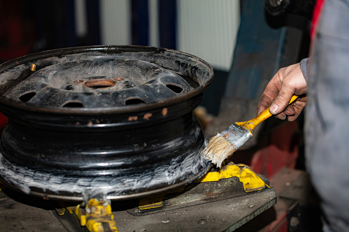 used tire mounting and inflating closeup on car service