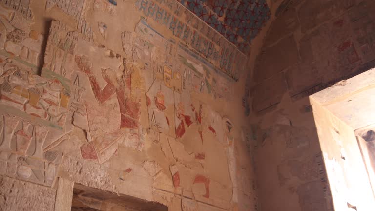 colorful hieroglyphs line the wall of ancient temples and tombs in the valley of the kings and hatshepsut temple