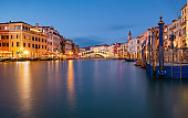 Very long exposure evening shot of Rialto bridge from Grand Canal water surface. Venice, Italy.