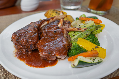 Close-up shot of Lamb Chops steak with Barbecue Sauce and mix vegetables