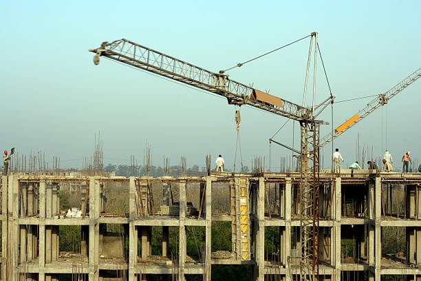 Construction Site Close Up Residential Flats Being Developed in Rural India. There are People working on the Construction Site. crane machinery photos stock pictures, royalty-free photos & images