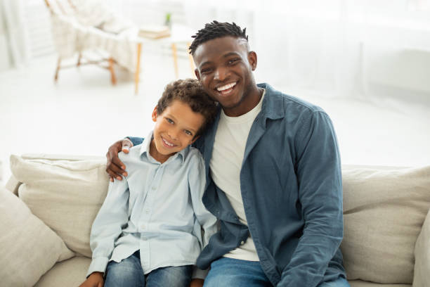 istock Happy Black Dad And Son Hugging Posing Together At Home 1794916261