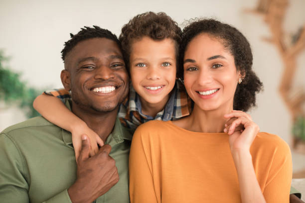 istock Cheerful Diverse Parents And Kid Son Hugging At Home 1794916870