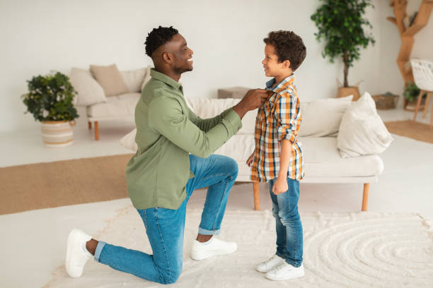 istock Black Father Getting His Kid Son Ready Buttoning Shirt Indoor 1794916894