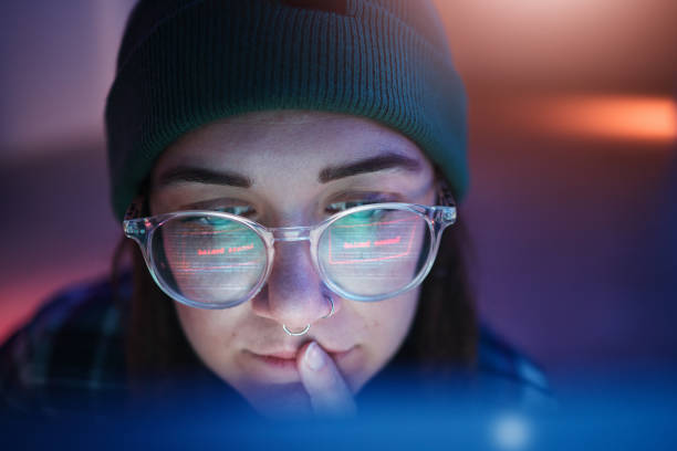 istock Cyber security, ransomware and woman hacker working on a computer in the basement at night for phishing. Database, password and malware with a female coder hacking a digital transformation network 1794918033