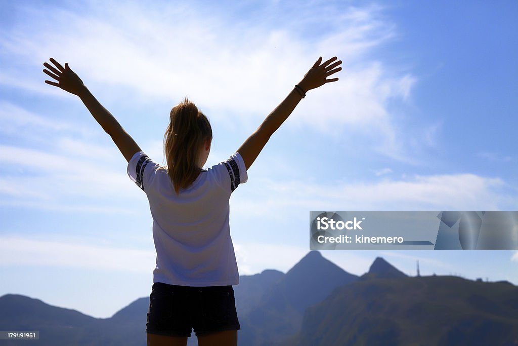 Silhouette spreading hands Silhouette of woman spreading hands with joy and inspiration on top of the mountain In Silhouette Stock Photo